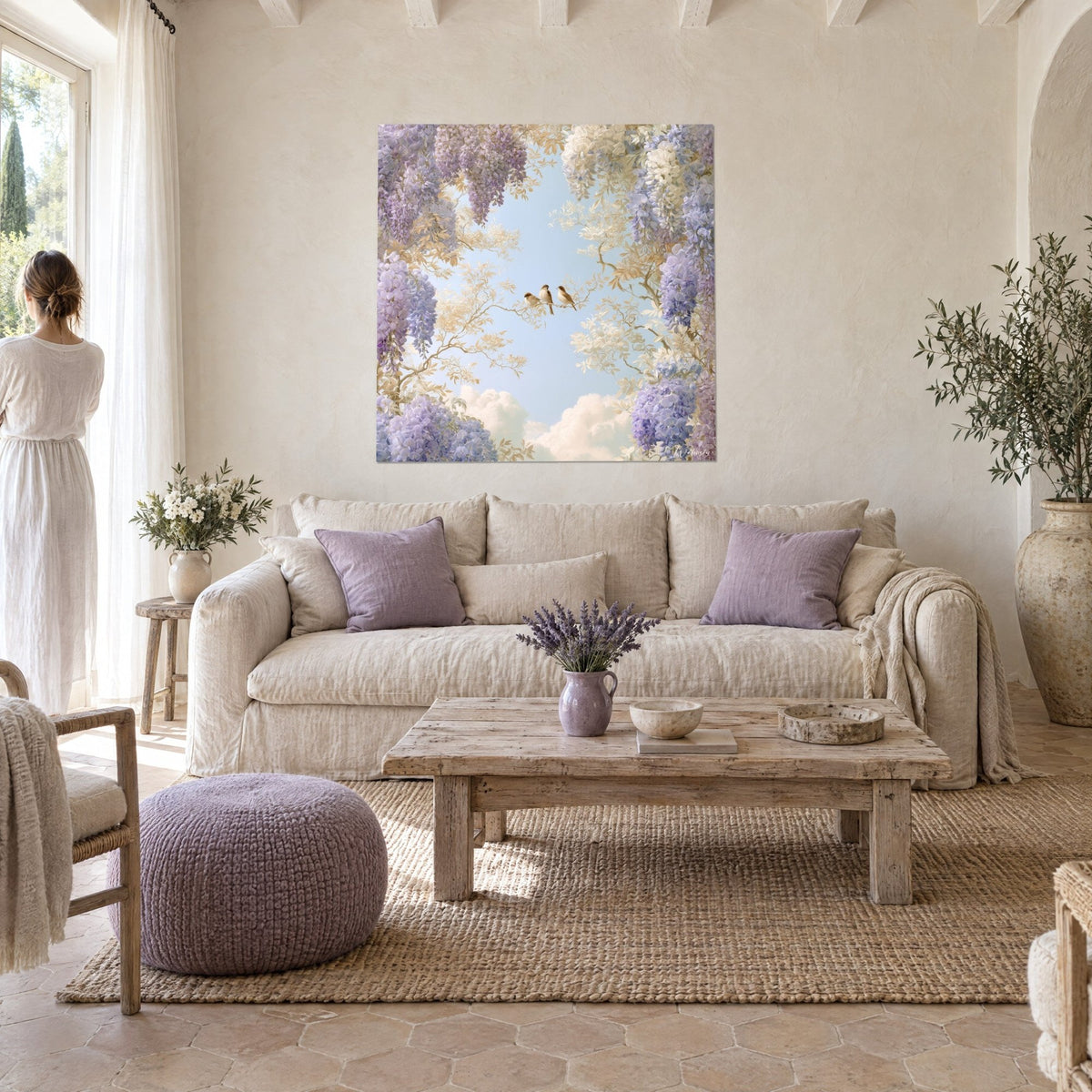 Wall art three sparrows lined up on a golden branch, mauve wisteria and pale blue sky, above a sofa in a bright living room