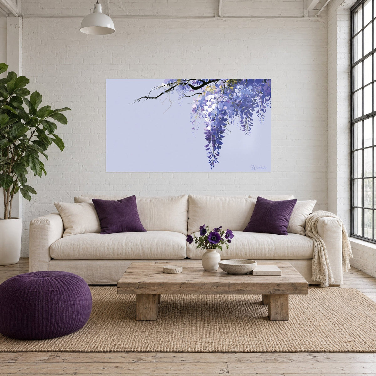 Wall art cascading wisteria, indigo and white flower clusters on lavender background, black branch, above a sofa in a bright living room