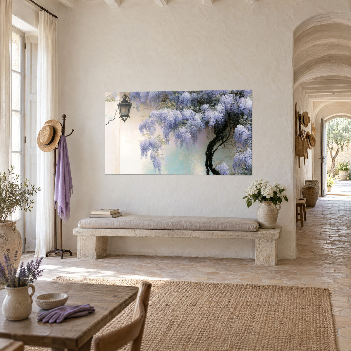 Wall art with a black wrought-iron lantern beneath lilac and white wisteria clusters, aged cream wall, stone bench in a Provençal farmhouse