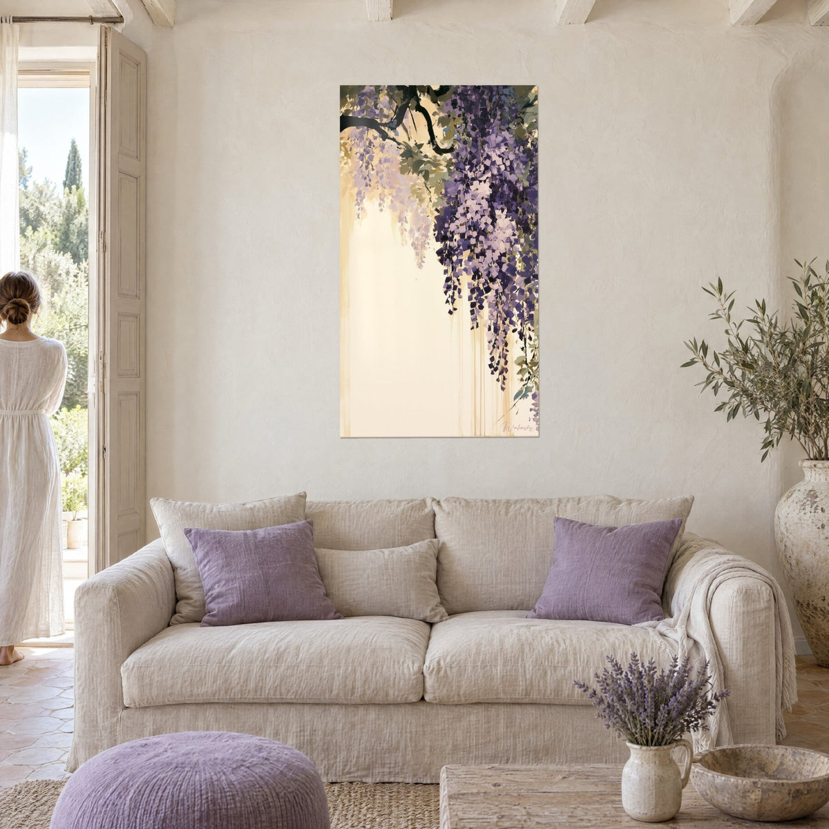 Wall art wisteria with violet and cream clusters hanging from a black branch, ivory background, above a sofa in a bright living room