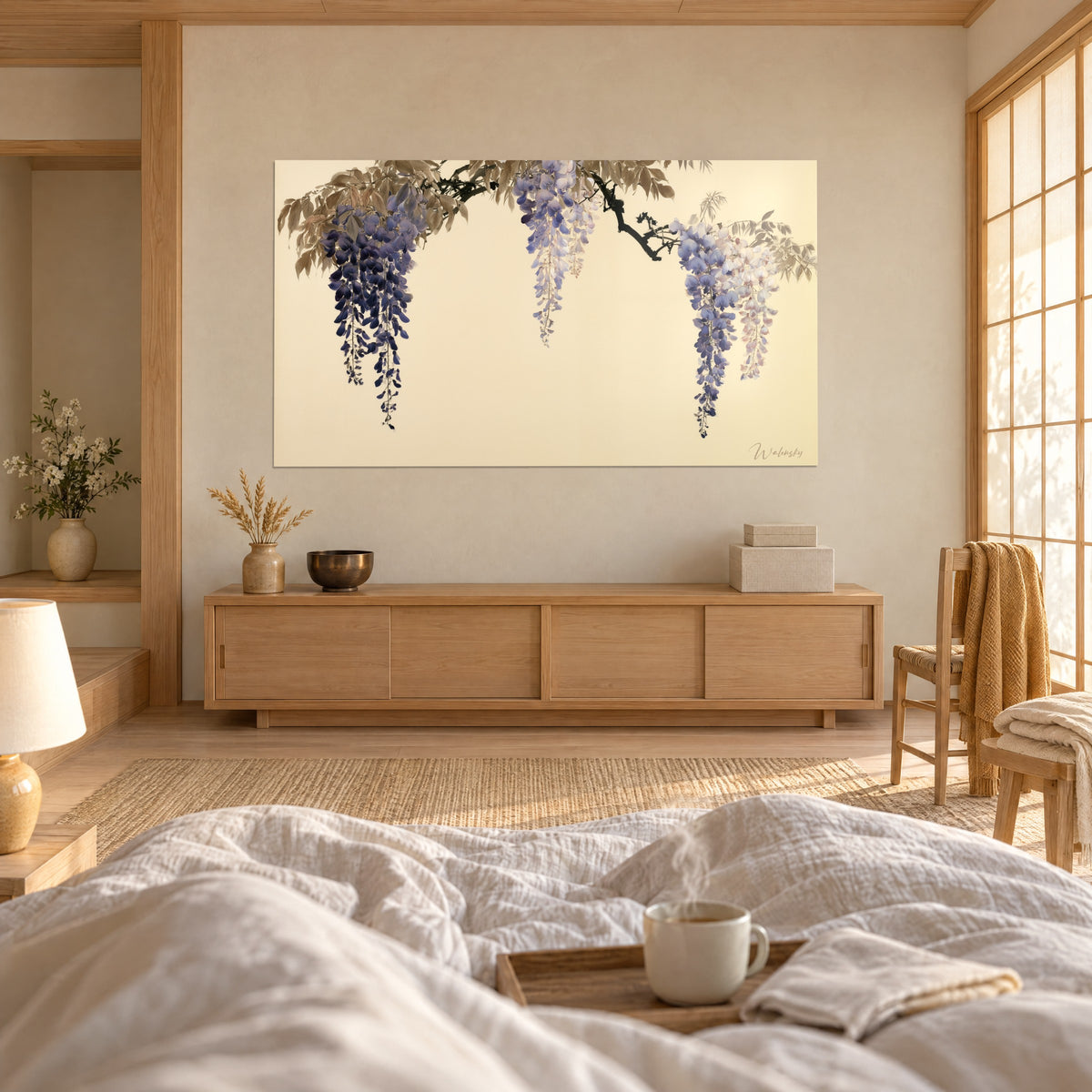 Schilderij hangende blauweregenbloesems in blauwpaars en lichtroze, beige blad, een persoon van achteren, boven een bed in een lichte slaapkamer
