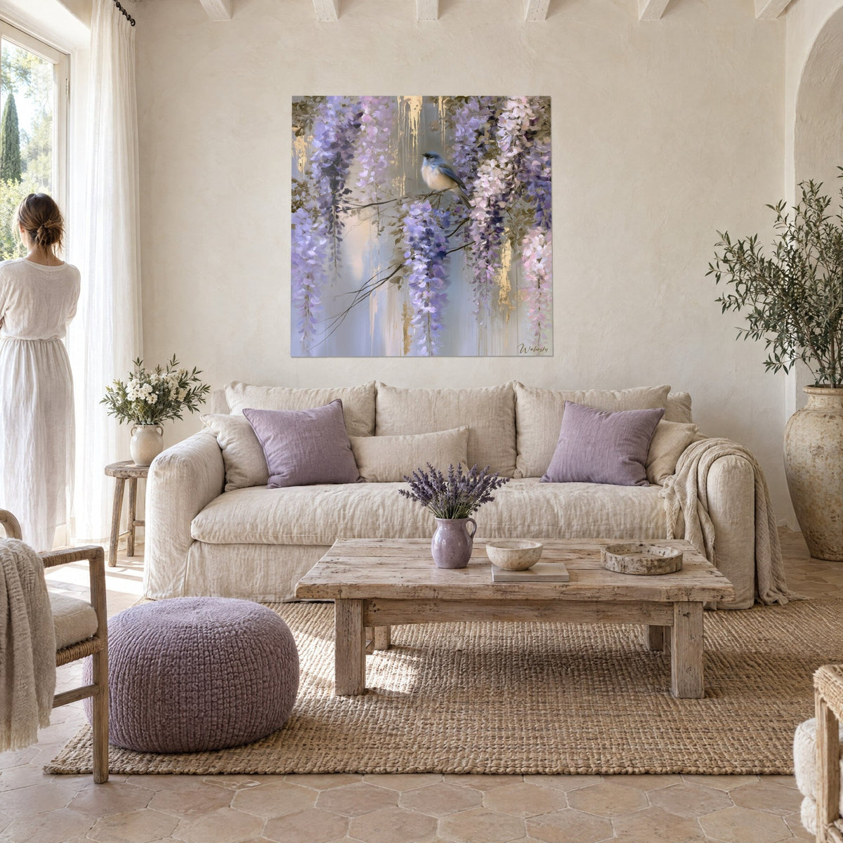 Quadro cincia dal ventre crema tra grappoli di glicine malva, sfondi grigi e oro, donna di spalle sopra un divano in un soggiorno luminoso