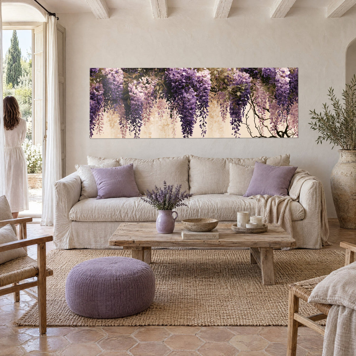 Wall art of violet and ivory wisteria clusters on bare branches, above a sofa in a bright living room