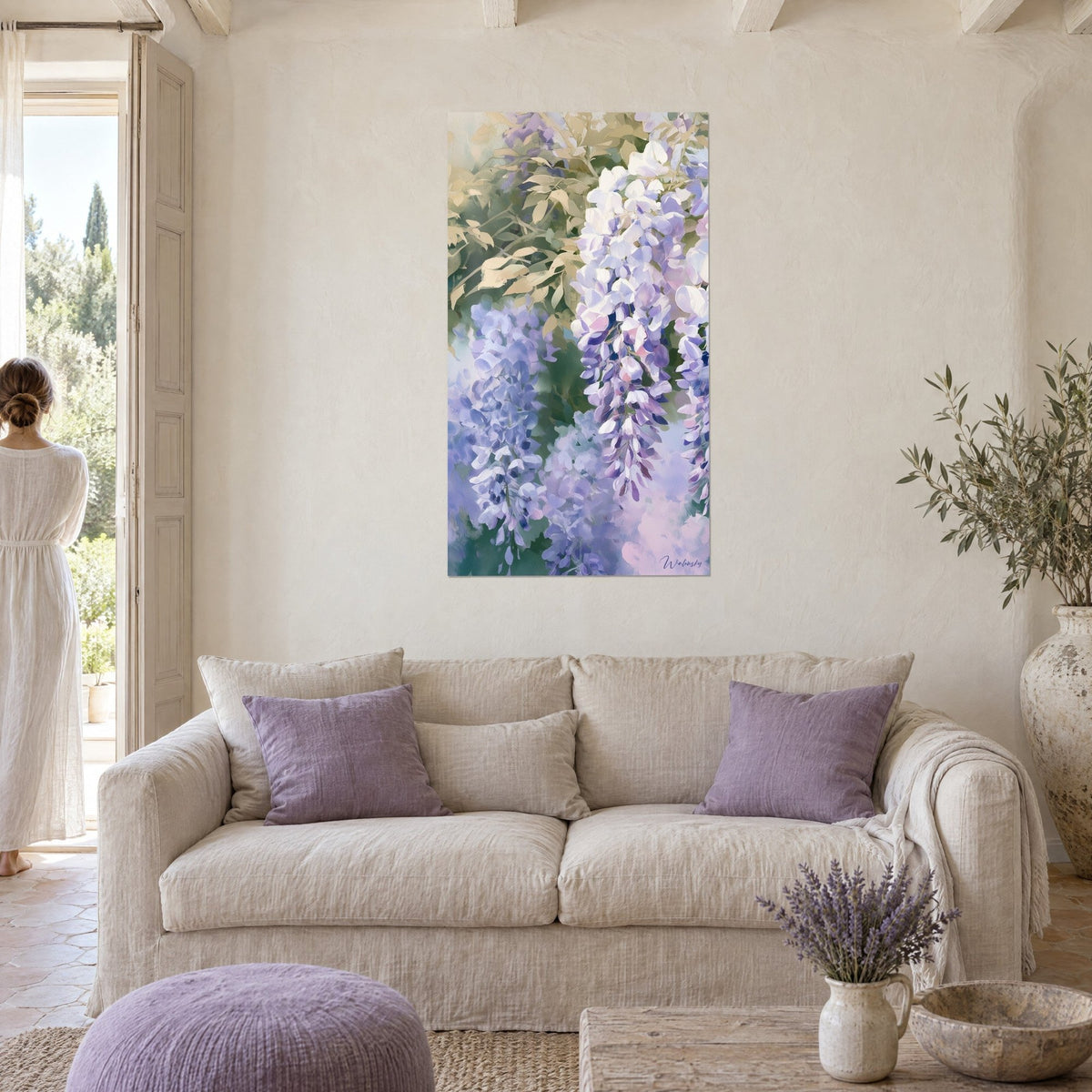 Wall art wisteria in lilac and white clusters under beige foliage, two women seen from behind, above a sofa in a bright living room