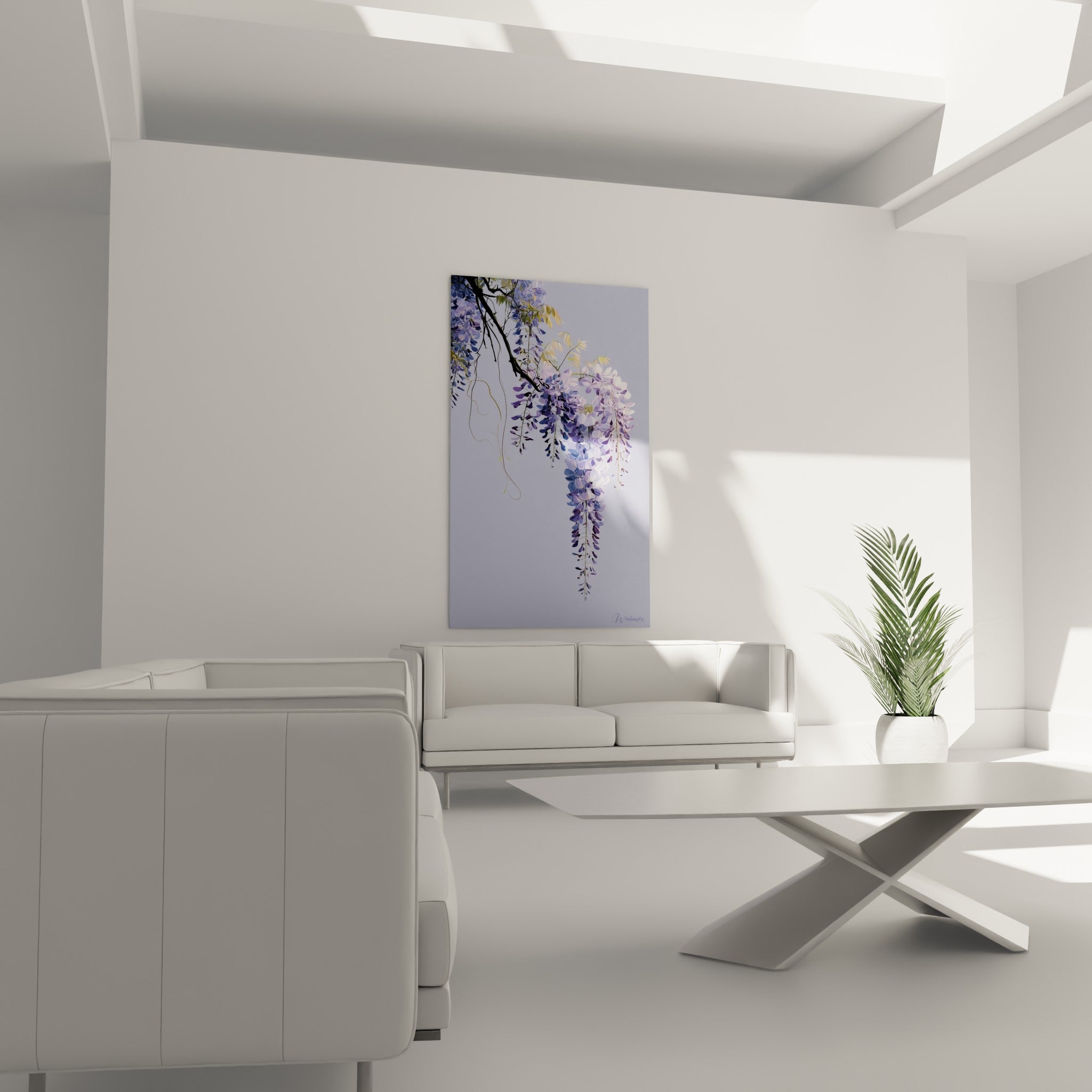 Branche de glycine violette et vert tendre suspendue au-dessus d'un canapé dans un salon lumineux