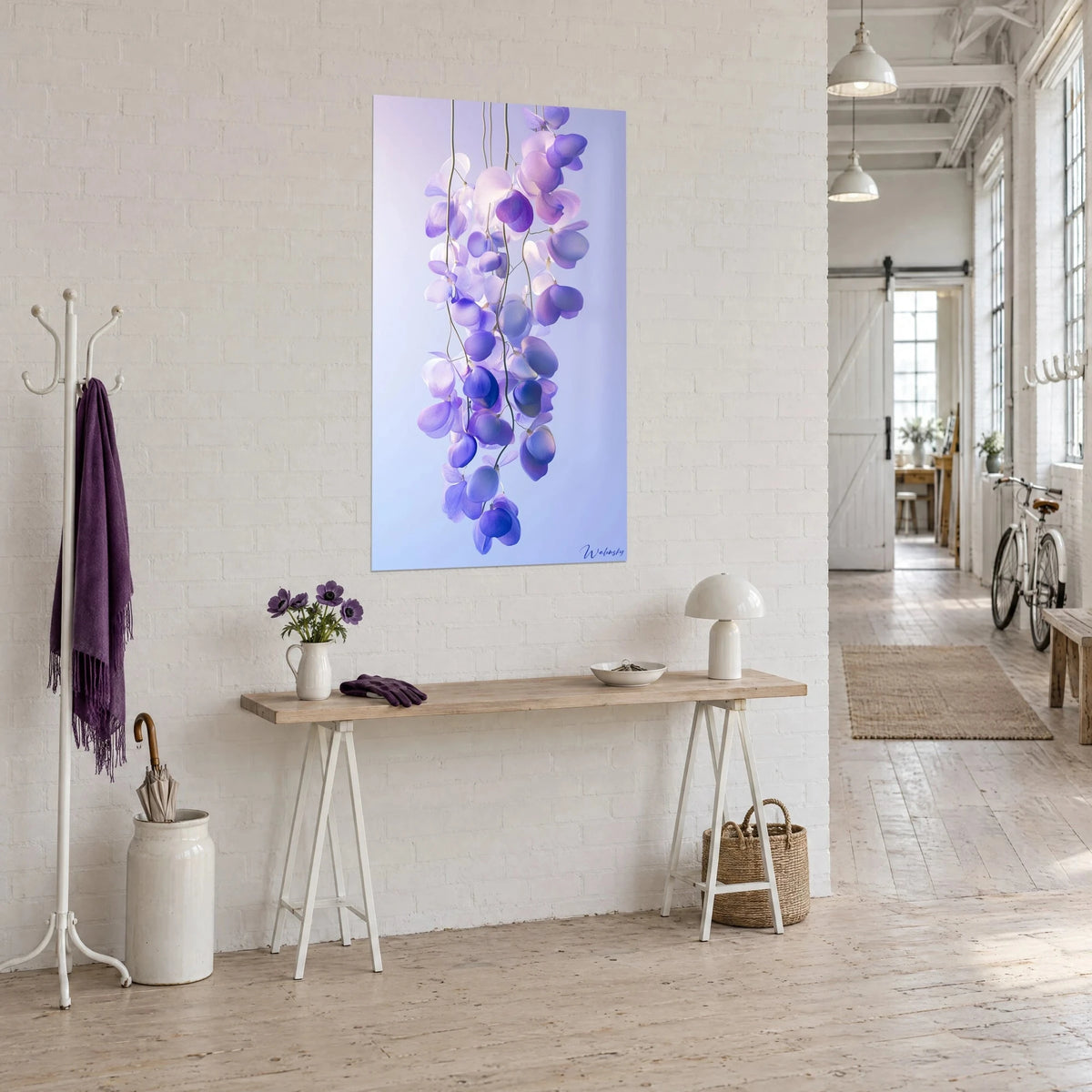 Wall art drooping flowers in mauve and periwinkle blue hanging from fine stems, on a white loft wall, three-quarter view