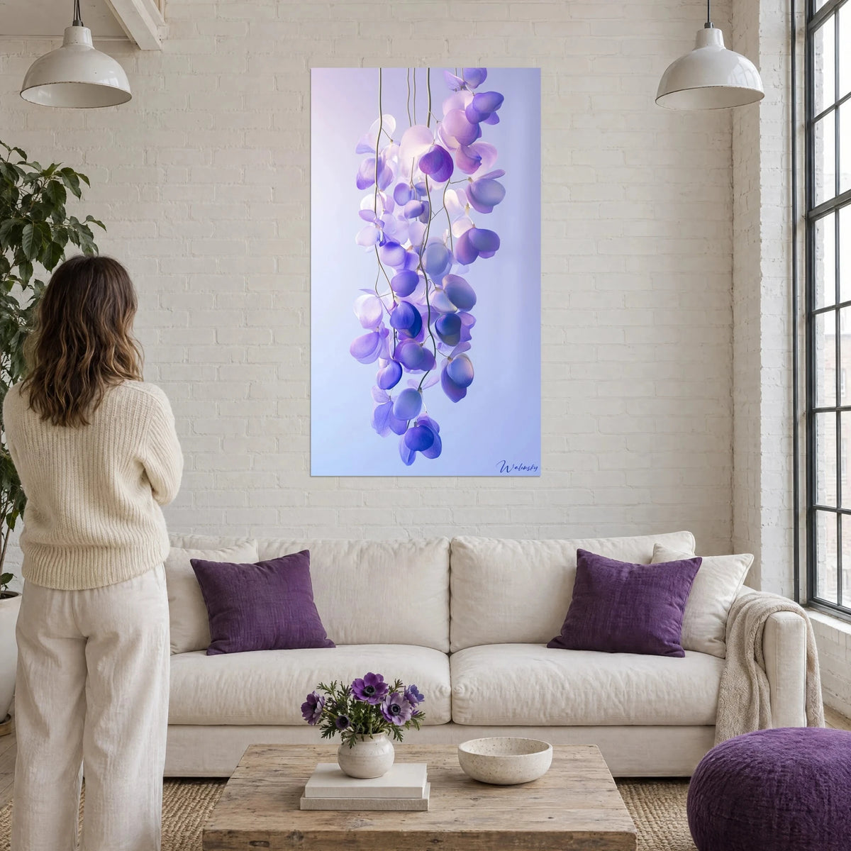 Wall art wisteria cluster in lilac and indigo, translucent petals on a gradient background, above a sofa in a bright living room