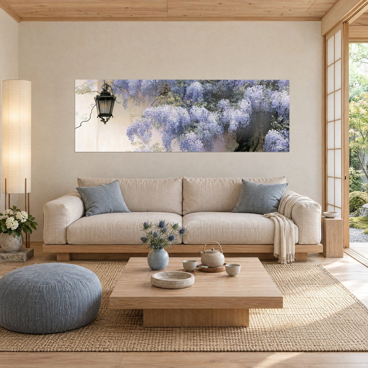 Wall art of mauve wisteria clusters cascading down a cream wall, black lantern hanging above, over a sofa in a bright living room