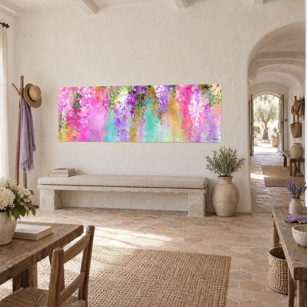 Wall art with a zesty floral cascade banner in fuchsia, lilac and mint green, hung in the vaulted hallway of the Provençal farmhouse