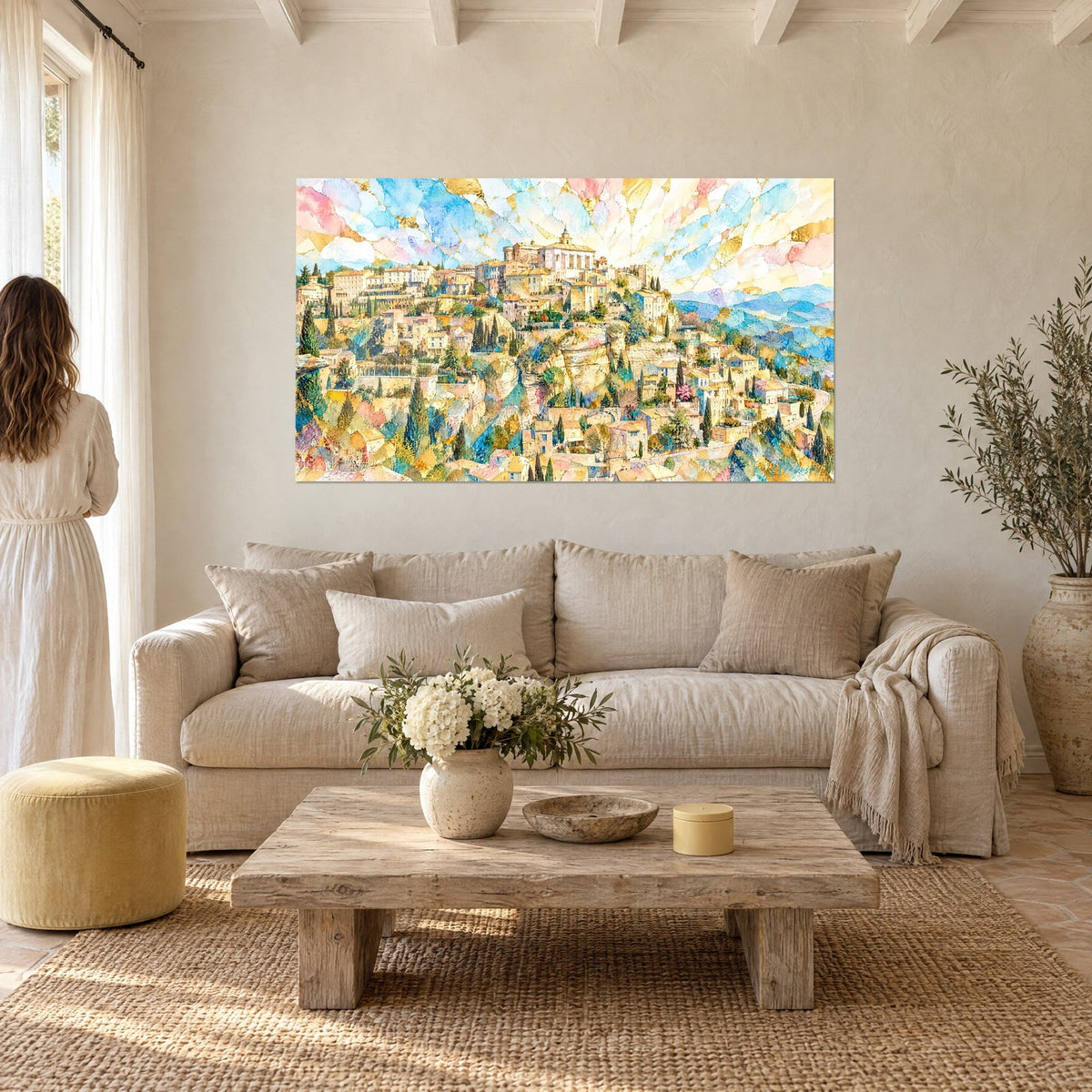 Wall art Gordes village in golden watercolor, pink and blue sky like stained glass, couple seen from behind, above a sofa in a bright living room