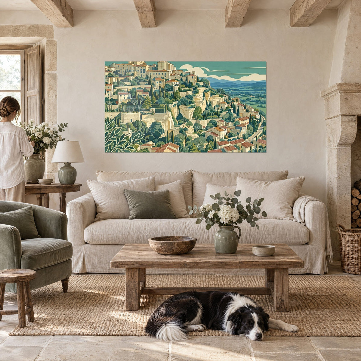 Quadro borgo arroccato con tetti in tegole rosse, falesia beige e cipressi verde oliva, sopra un divano in un soggiorno luminoso