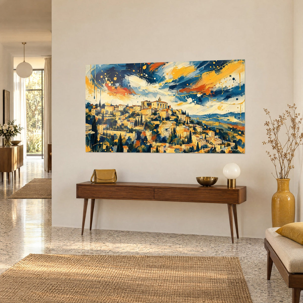 Wall art medieval town with orange rooftops under a swirling navy and yellow sky, on a beige wall, above a wooden console table