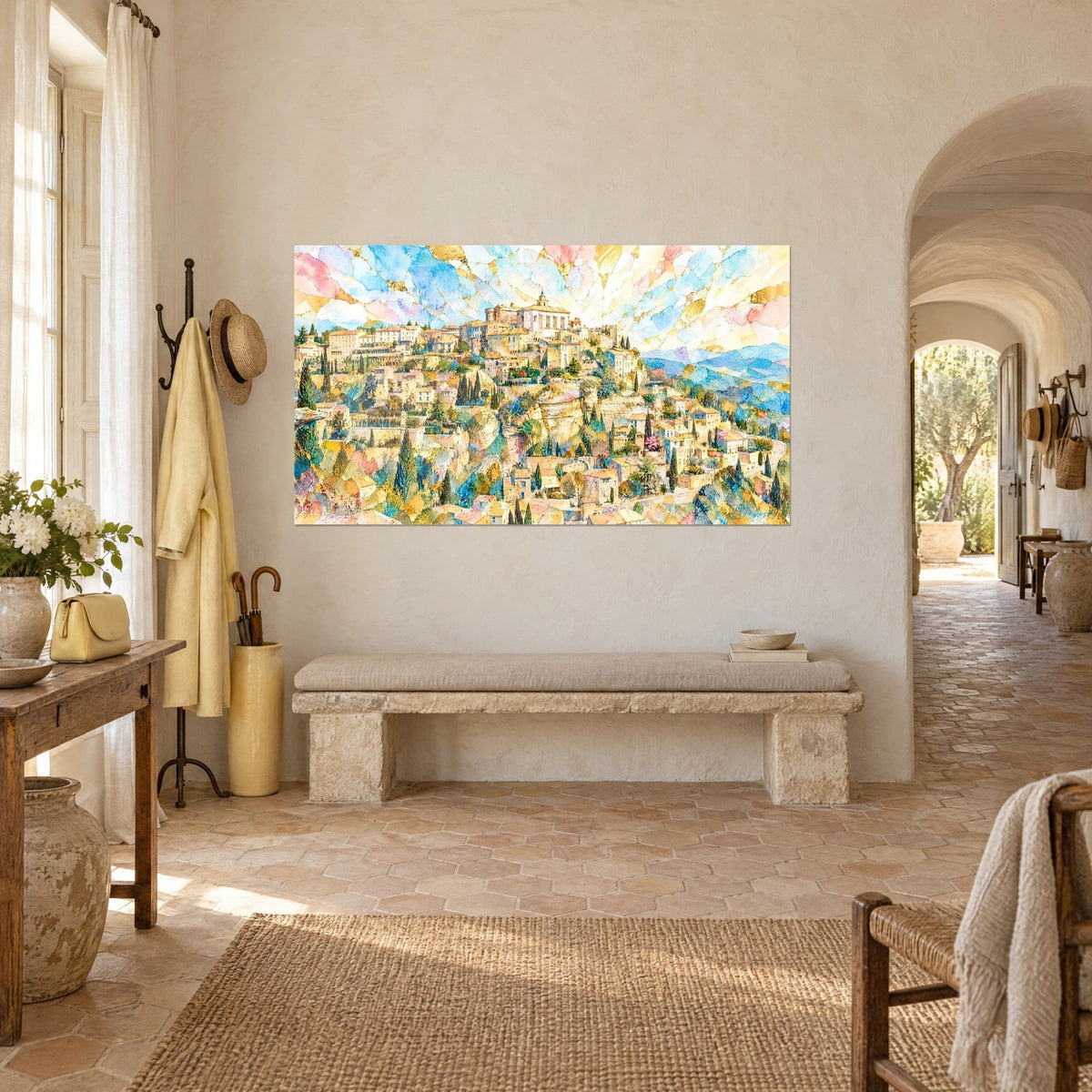 Wall art golden stone town on its hilltop, green cypress trees and shattered sky in blue and pink, hung beside a stone bench in a farmhouse