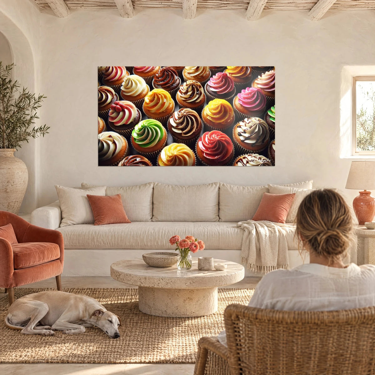 Wall art cupcakes with swirled pink and apple-green frosting, glossy caramel pools, hung above a sofa in a bright living room