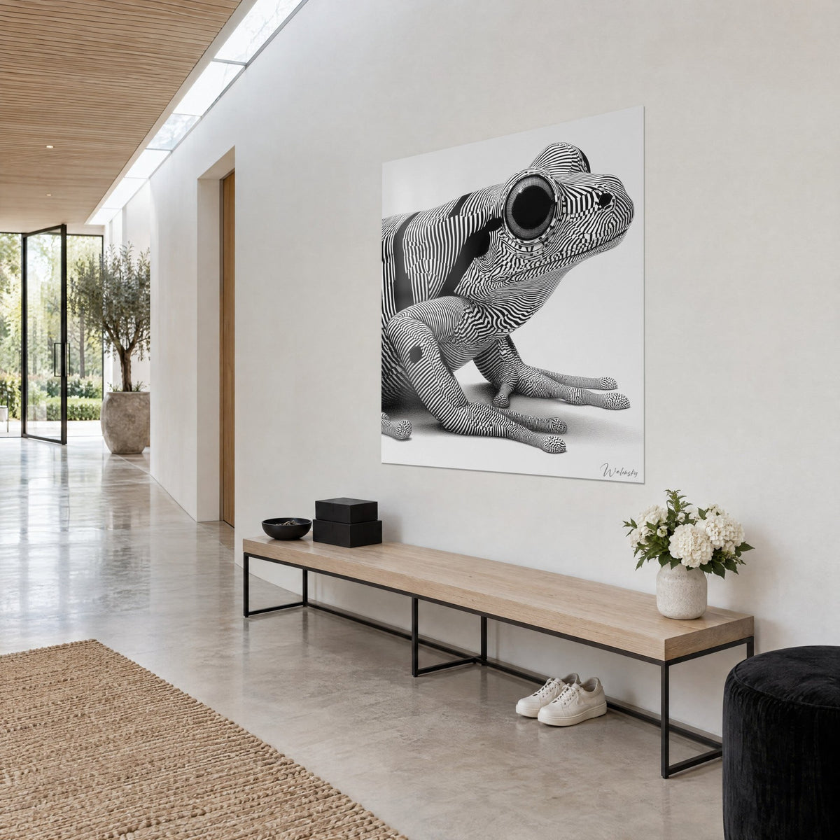 Wall art of a stocky amphibian in wavy black and white lines, toes with engraved detail, pearl grey background, three-quarter view in a bright hallway
