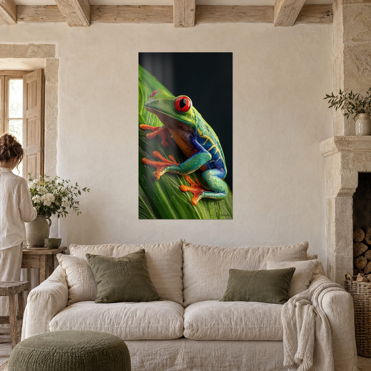 Wall art red-eyed tree frog, green body and blue flanks, orange feet on a leaf, hanging above a sofa in a bright living room