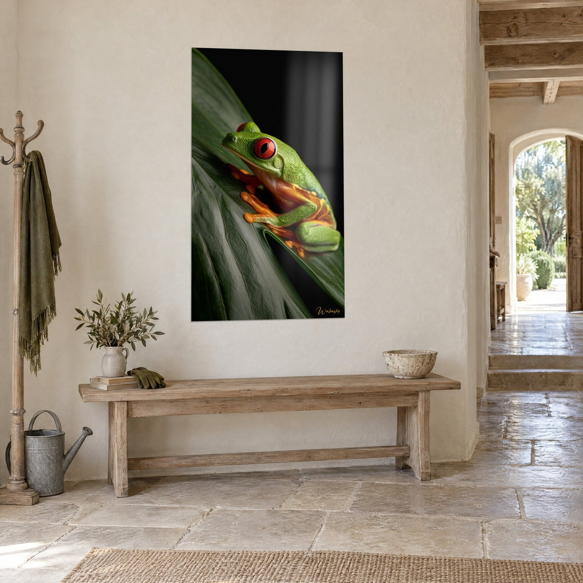 Wall art apple-green and orange tree frog, scarlet eye, tilted leaf, three-quarter view in a stone hallway