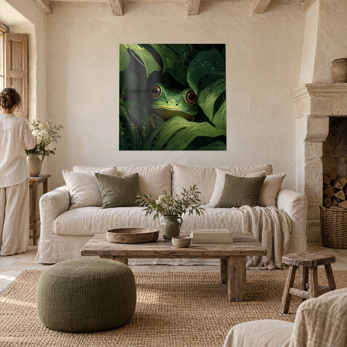 Wall art of a frog with brown eyes ringed in gold, green glittering skin among broad leaves, above a sofa in a bright living room