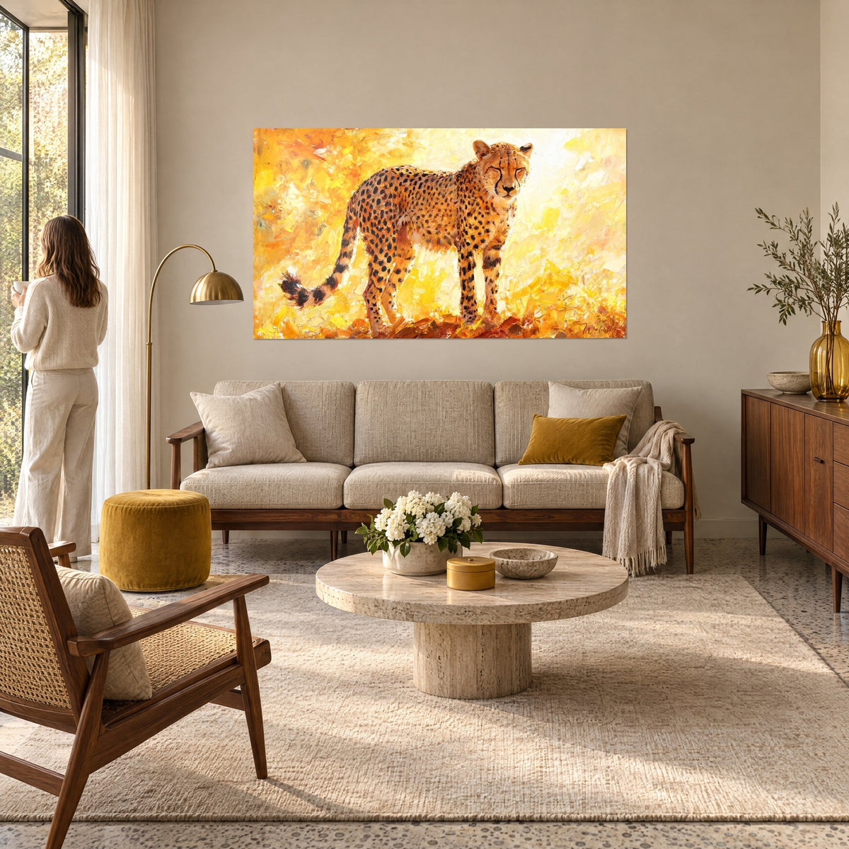 Wall art of a spotted big cat with half-closed eyes, golden yellow and orange background, woman seen from behind, above a sofa in a bright living room