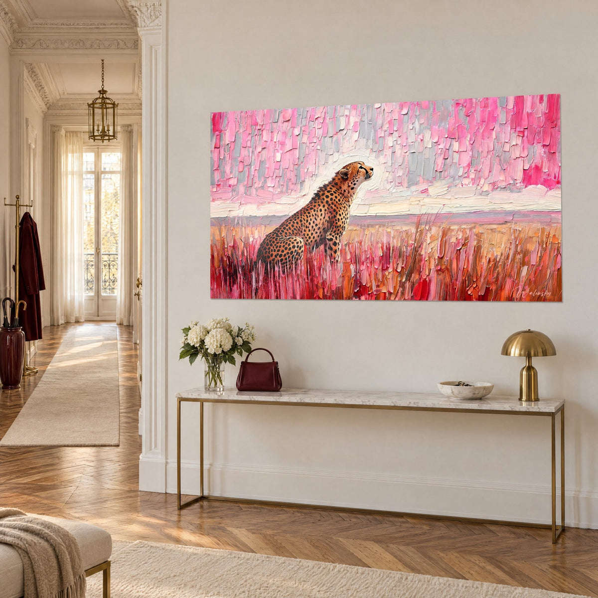Wall art of a cheetah standing tall facing the horizon, orange coat dotted with black, powdery pink sky, on a beige Haussmann-style wall