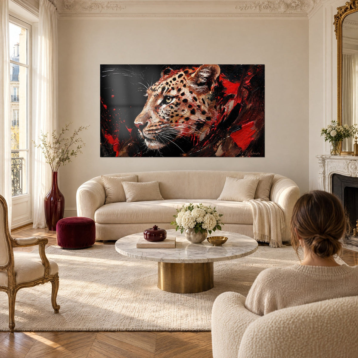 Tableau guépard fauve à la robe tachetée, éclaboussures rouge vif sur fond noir, au-dessus d'un canapé dans un salon lumineux