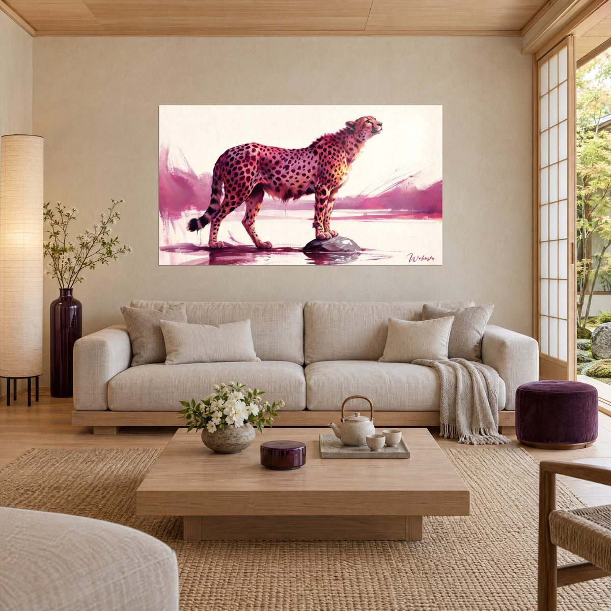 Wall art spotted cheetah in pink and fawn standing on a rock, purple reflections in the water, above a sofa in a bright living room