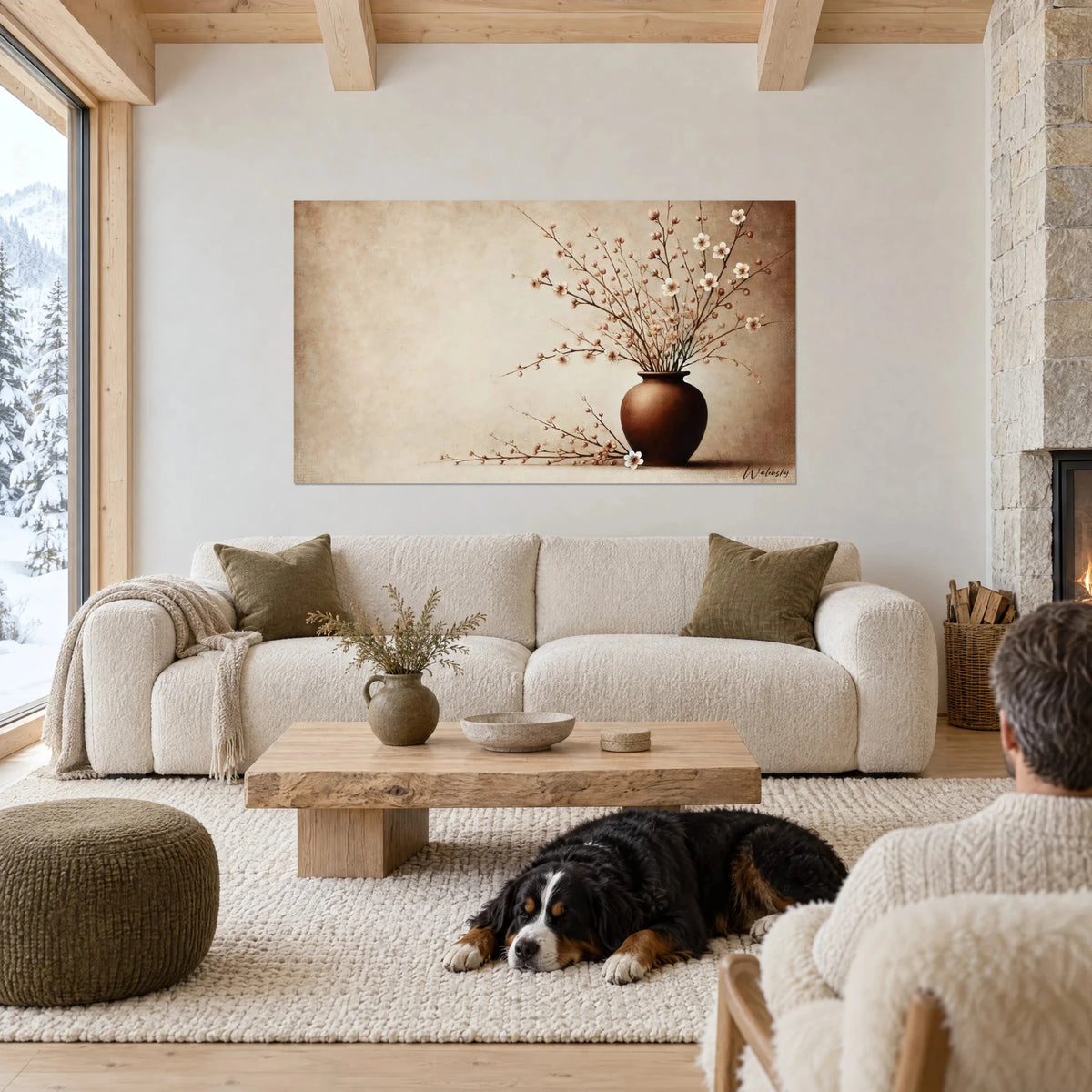 Wall art cherry blossom branches in a brown vase, beige and pale pink, black dog lying down, above a sofa in a bright living room