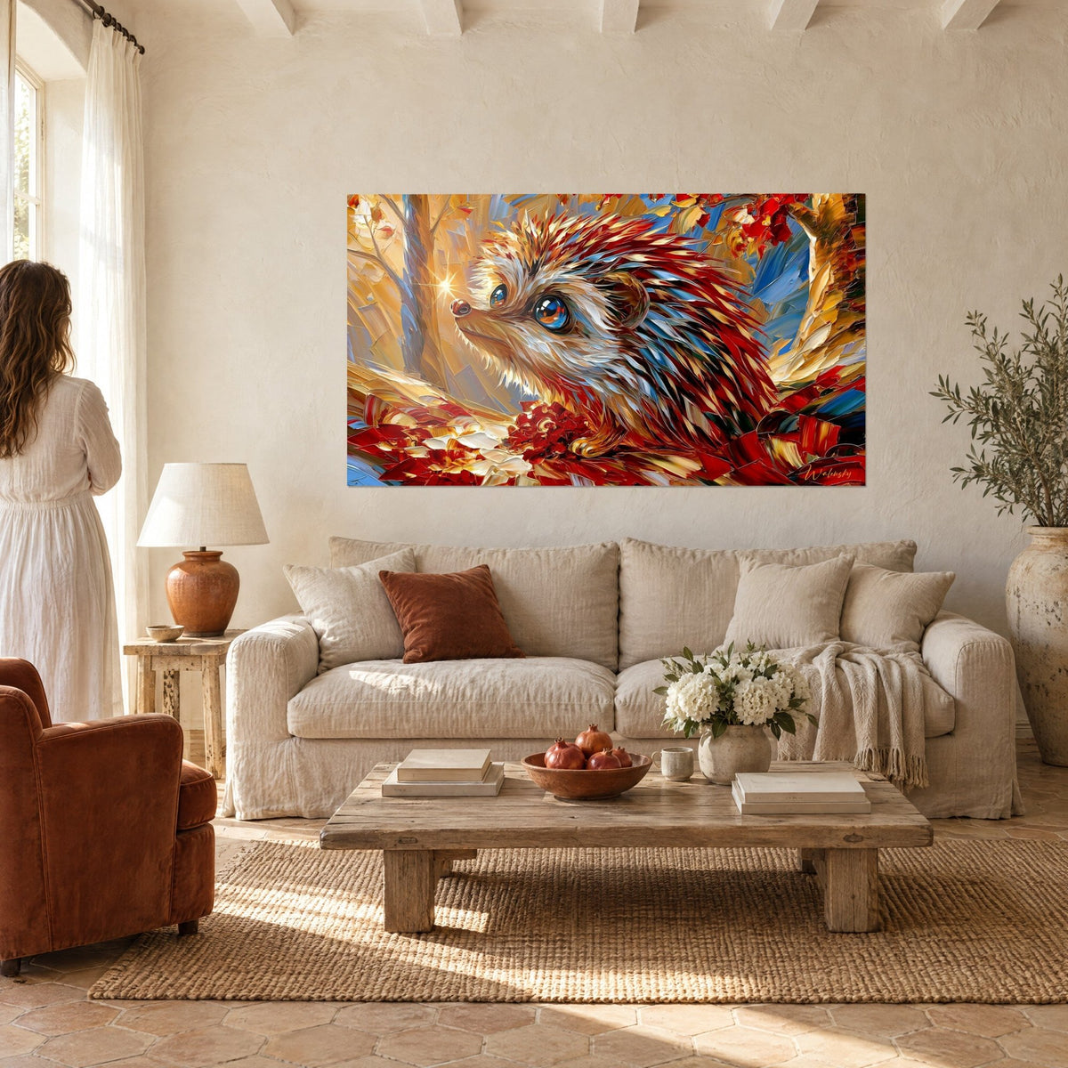 Wall art hedgehog with carmine red and gold quills, bright blue eye, facing a woman seen from behind, hung above a sofa in a bright living room