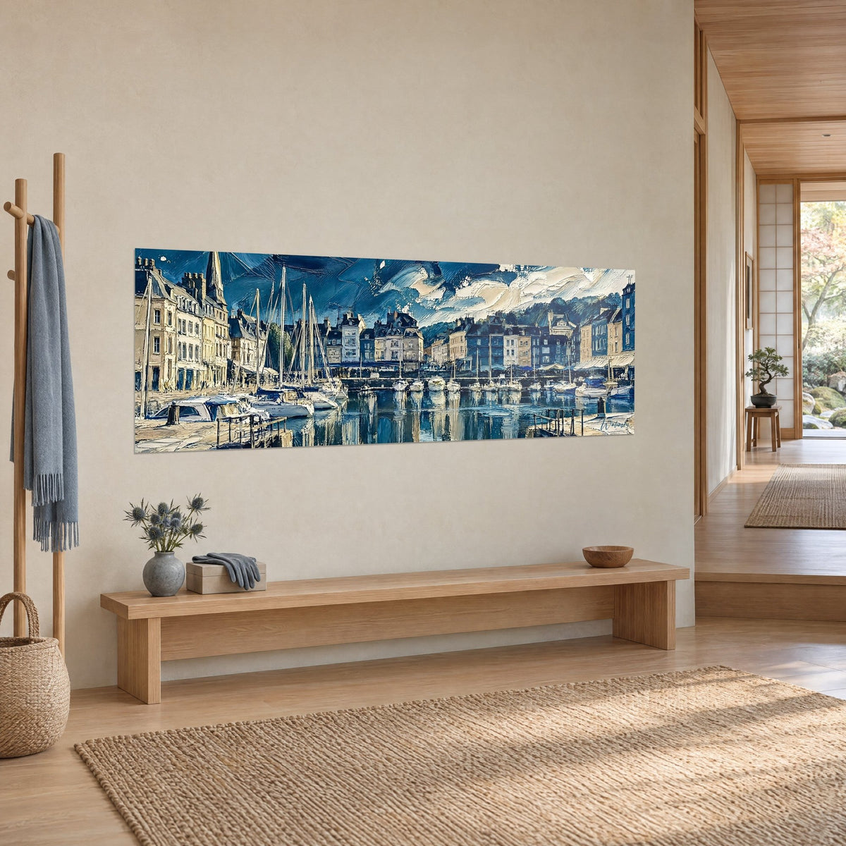 Wall art of a quayside with cream and slate houses, tall sailboat masts, blue reflections on the water, three-quarter view above a beige wall