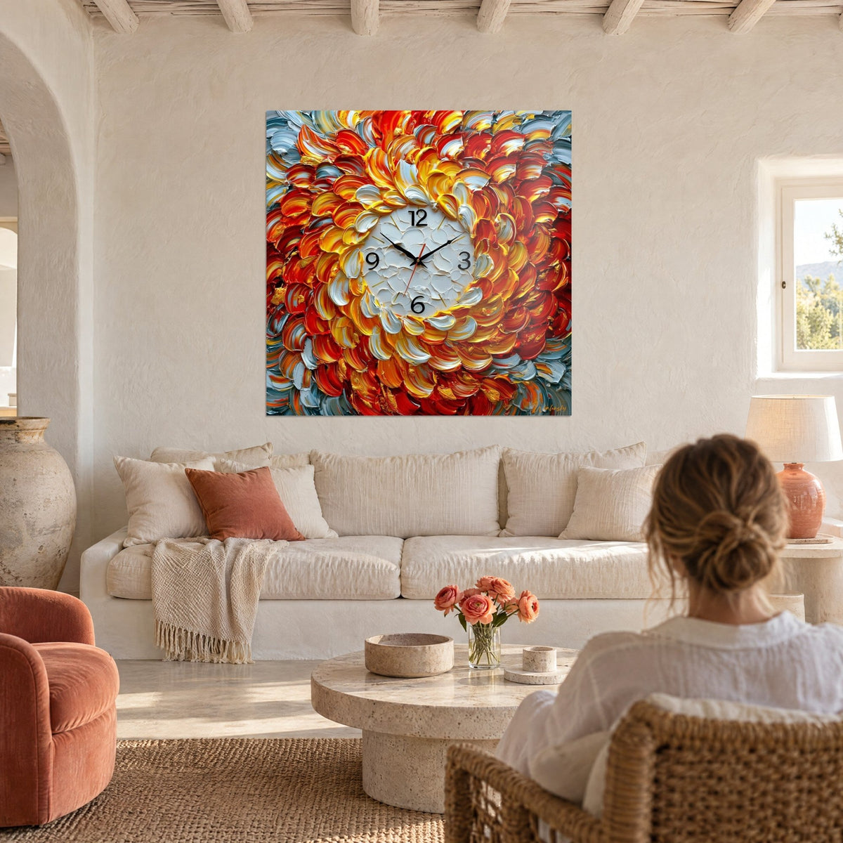 Wall art clock with a glowing flower of red and yellow petals, cracked white dial, above a sofa in a bright living room