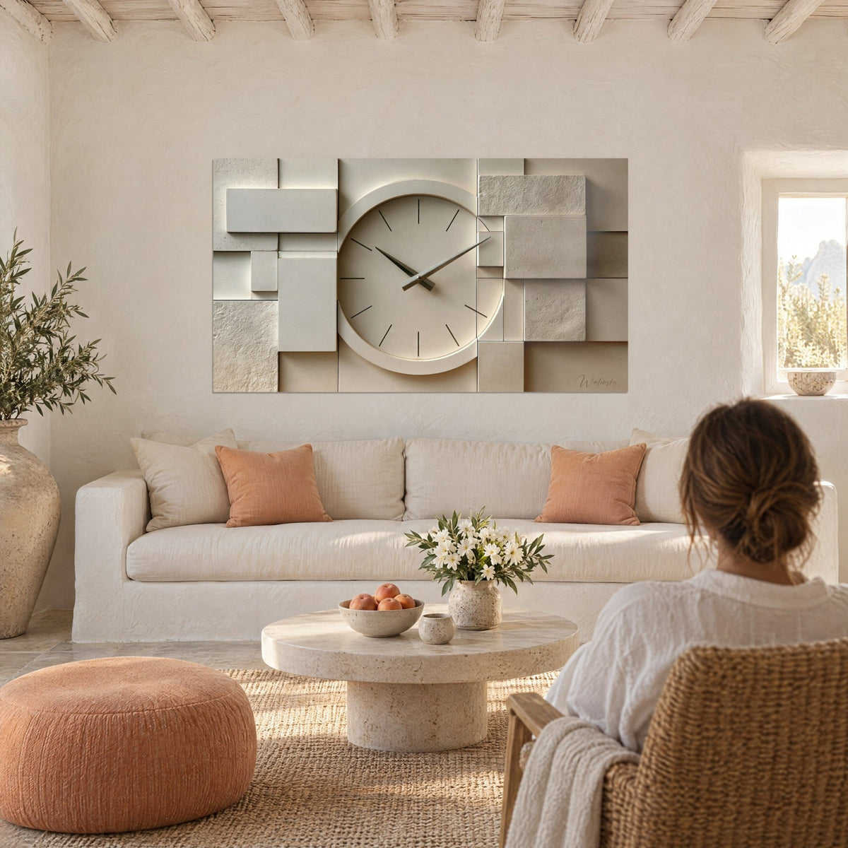 Wall art round clock with grey hands on beige and white stone blocks, above a sofa in a bright living room