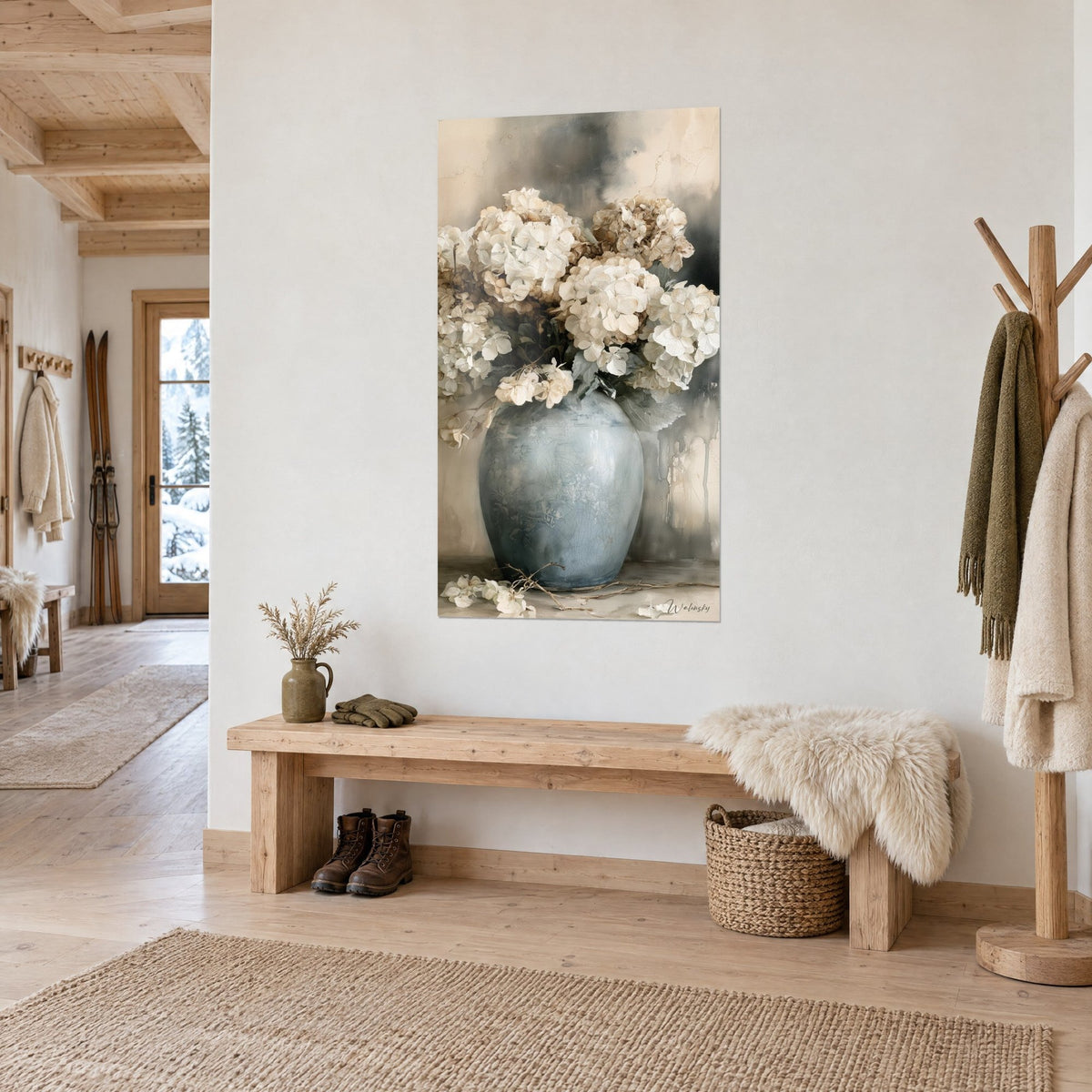Wall art of a bulbous crackled blue-grey vase, faded ivory hydrangeas and twigs on the floor, in a wooded chalet entrance