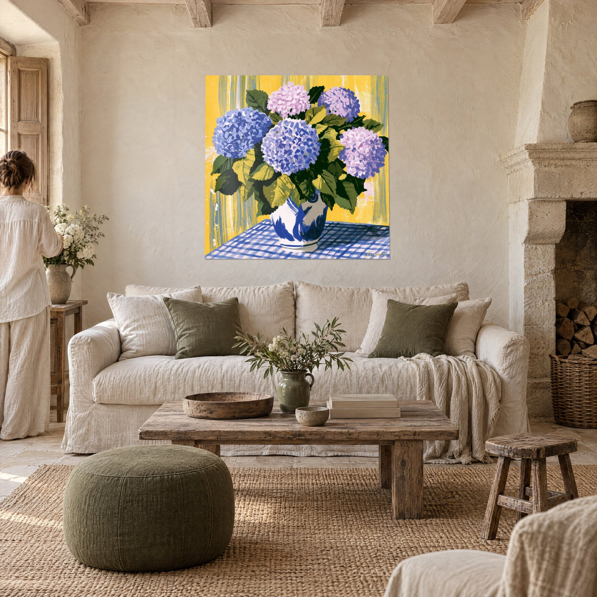Wall art cobalt blue and lilac hydrangeas in a white vase, mustard yellow background, checkered tablecloth, above a sofa in a bright living room
