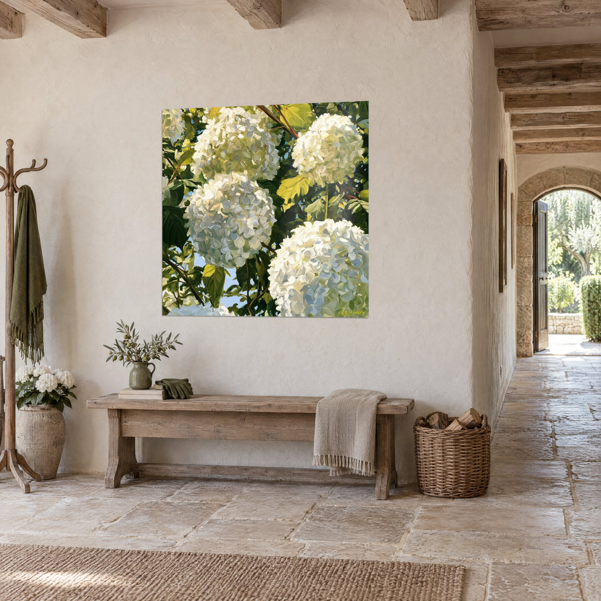 Wall art with clusters of cream hydrangeas in full light, dark green foliage and blue sky, in an entrance hall of old stone