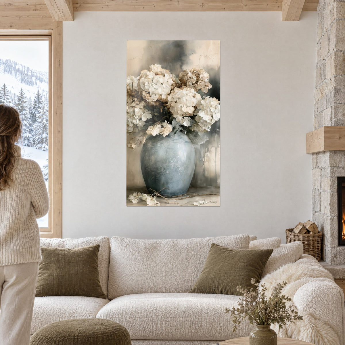 Wall art of a cream hydrangea bouquet in a crackled blue-grey vase, stained beige background, above a sofa in a bright living room