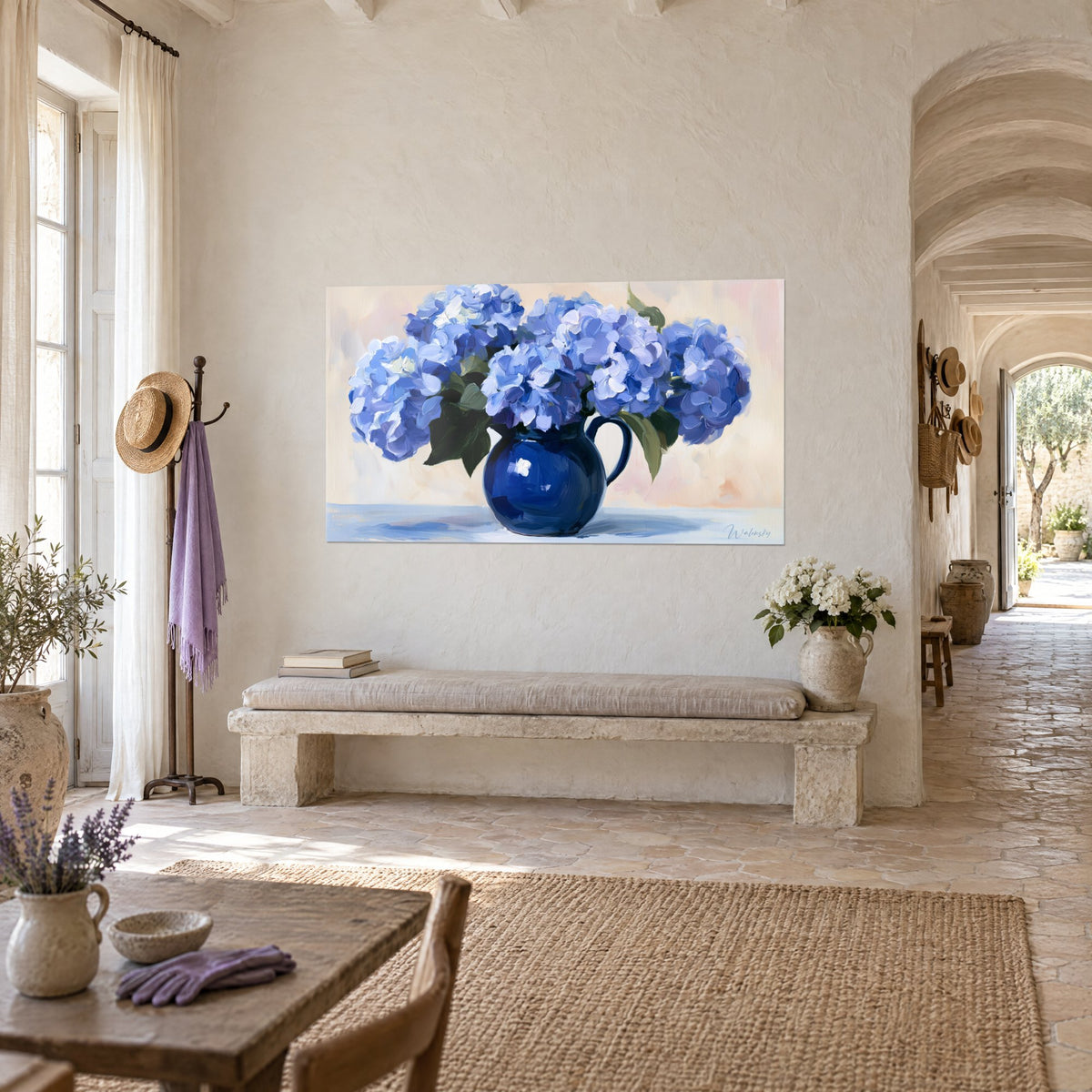 Wall art navy blue pitcher with white highlights and periwinkle blue flowers, cream background, facing a stone bench in a Provençal farmhouse