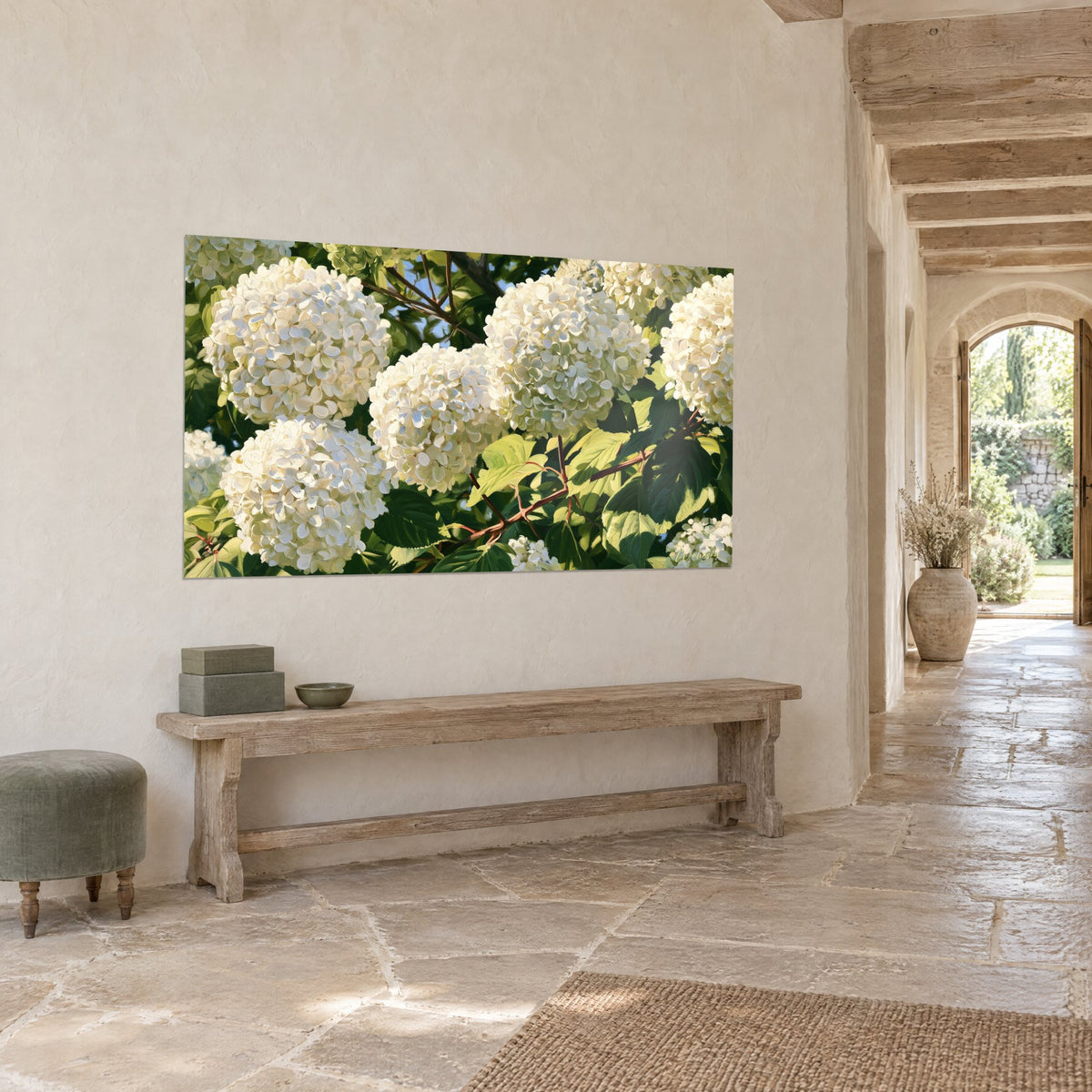 Wall art bouquet of cream pompoms and dark green foliage, copper stems on a diagonal, on a whitewashed wall of a vaulted gallery