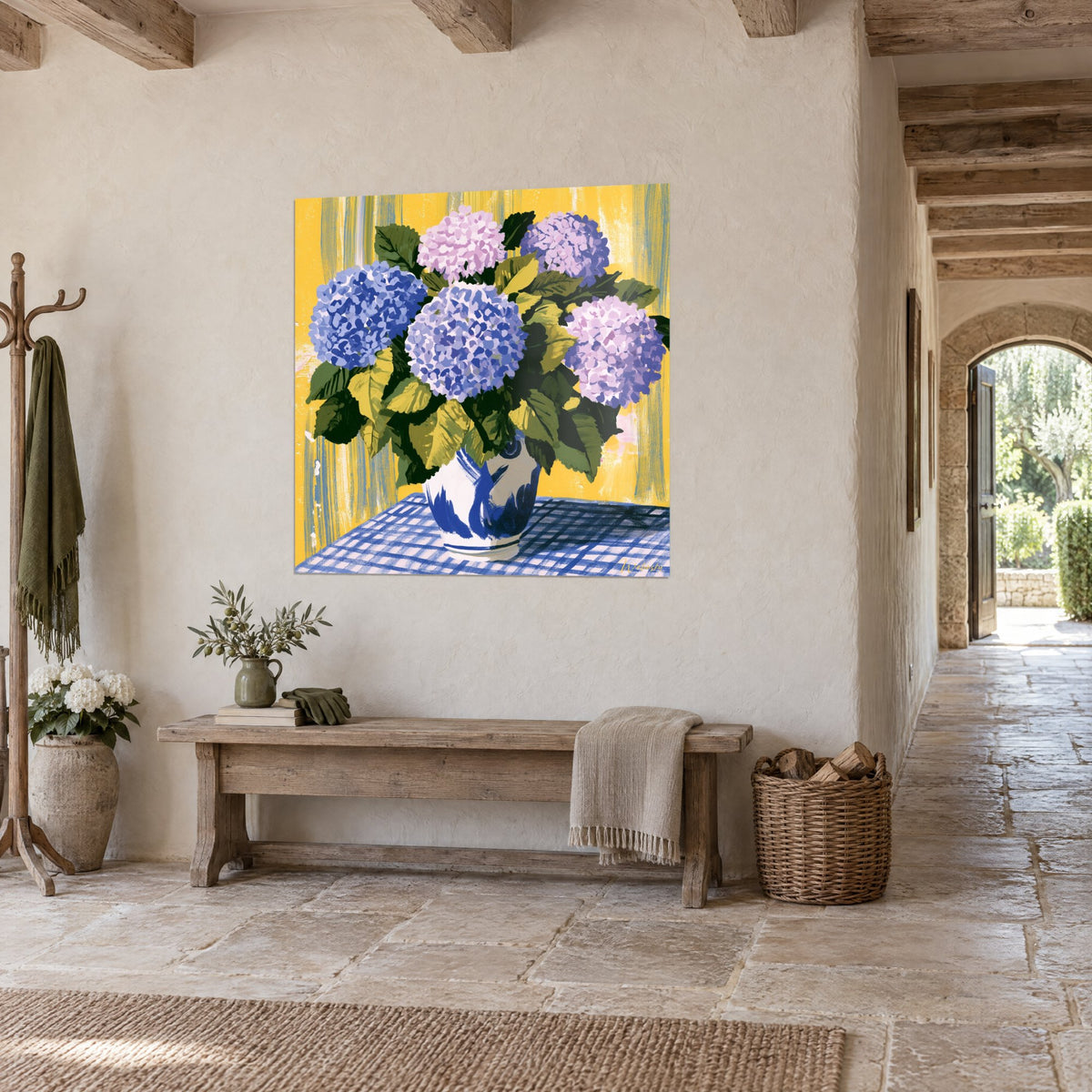 Wall art bouquet of mauve and pink hydrangea blooms on a blue gingham tablecloth, olive green foliage, ochre yellow wall, three-quarter view in a stone corridor