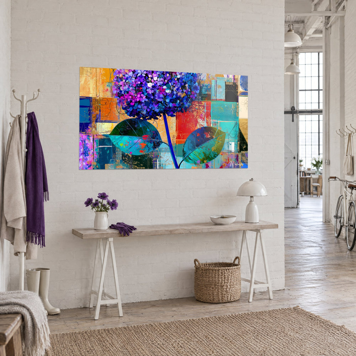 Wall art bouquet of mauve flowers on a blue stem, orange and vivid turquoise collage, facing a white brick wall in an artist's loft