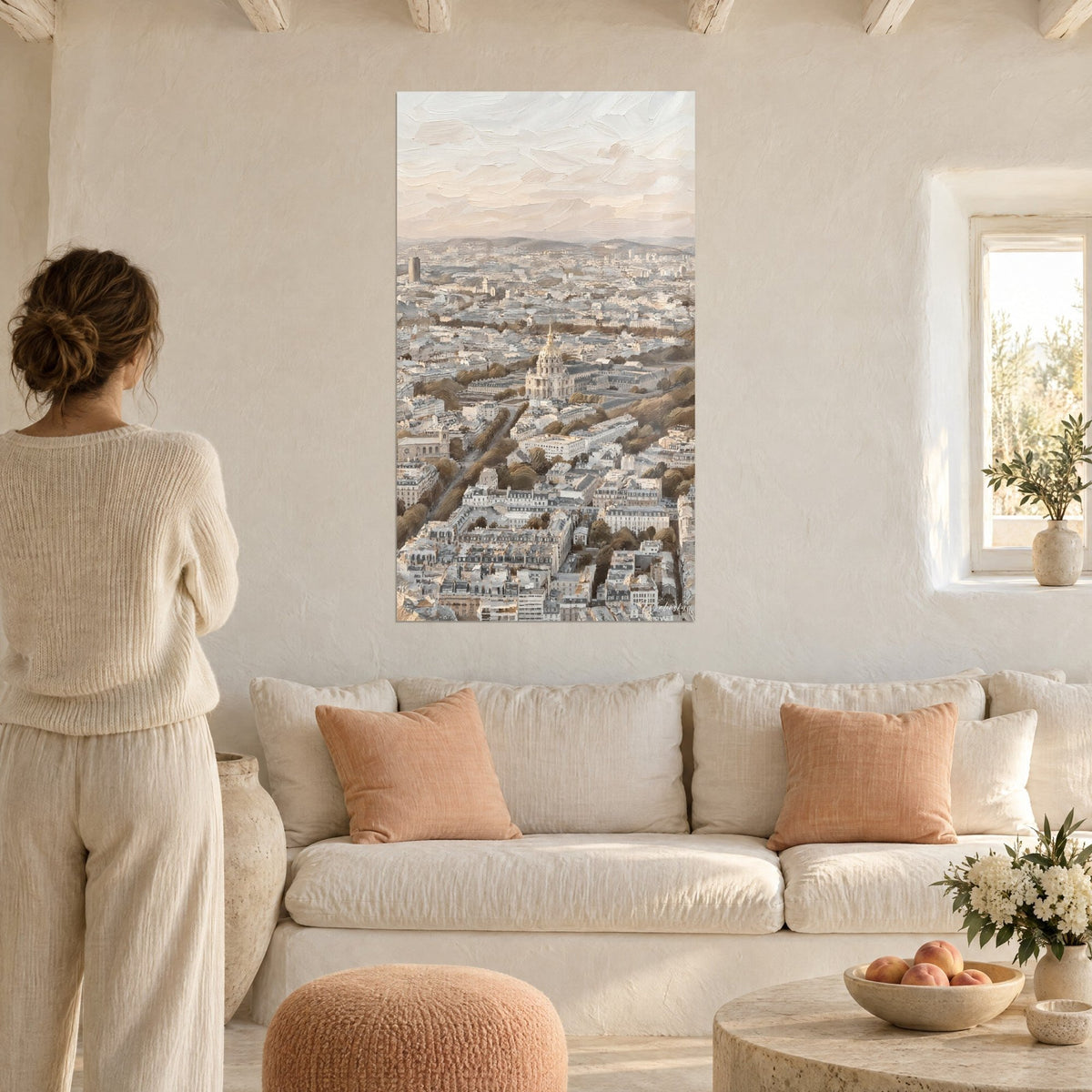 Wall art golden dome of Les Invalides rising above grey-blue rooftops, pale pink sky, woman seen from behind above a sofa in a bright living room