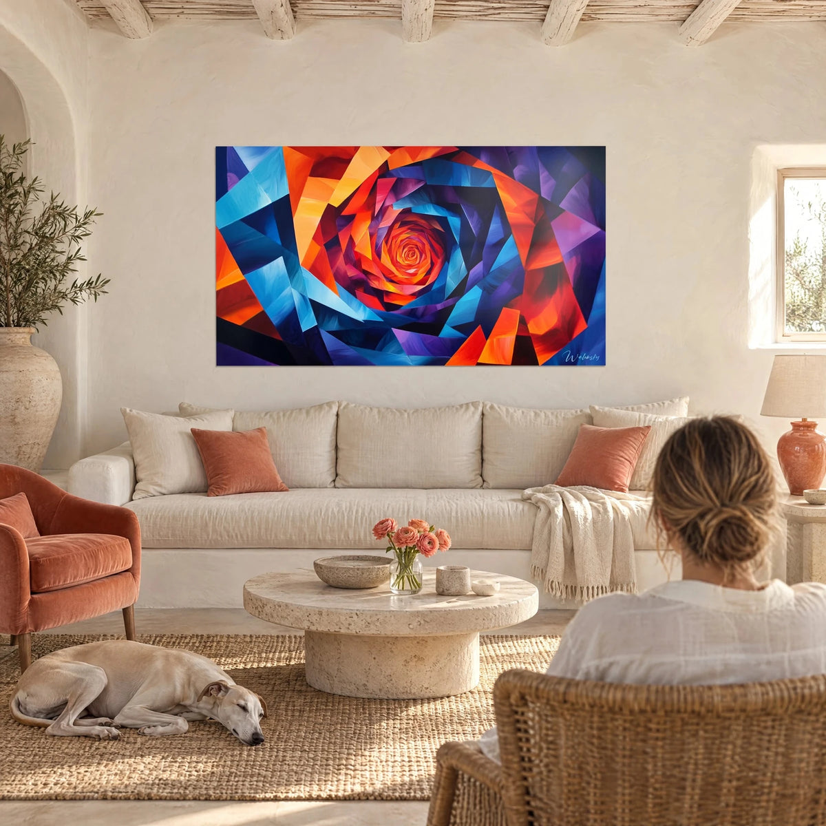 Wall art Geometric spiral in orange and electric blue with violet shards, two people seen from behind and a greyhound, above a sofa in a bright living room