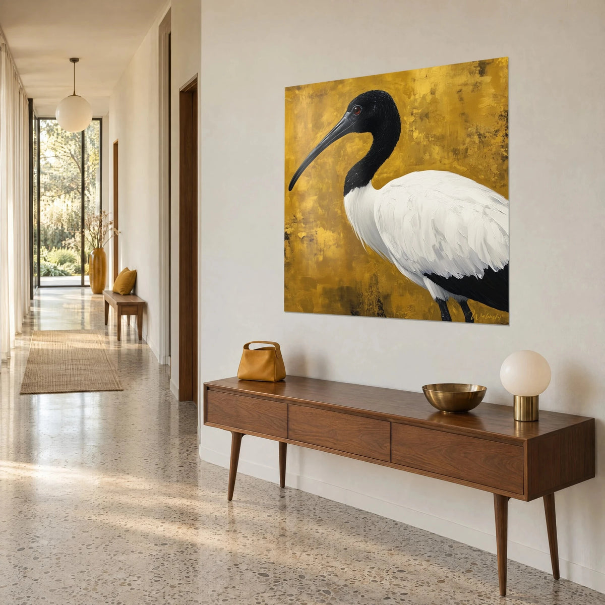 Wall art sacred bird of Egypt with white plumage and black head, textured gold background, hung above a wooden console