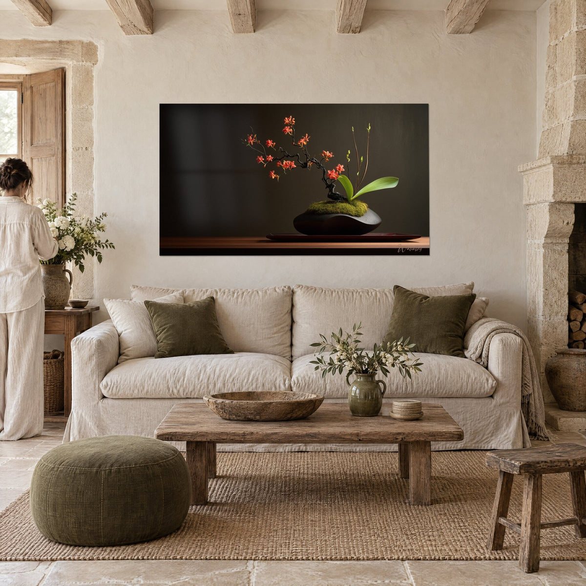 Wall art of orange orchids on a sculpted black branch, dark vase and green moss, above a sofa in a bright living room