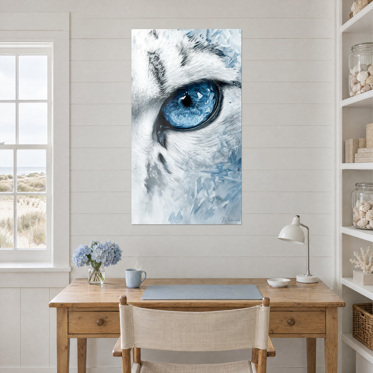 Wall art of a close-up portrait of a white cat, sapphire eye and slate-toned features, on the wall of a light wood office near shelves