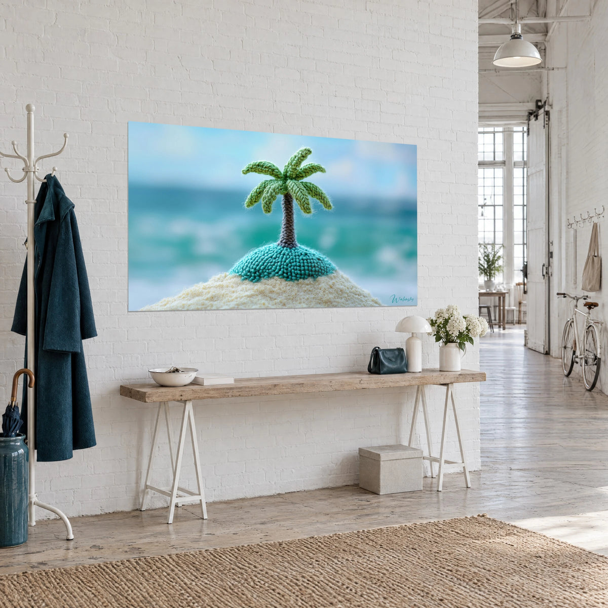 Wall art knitted miniature island, grey-brown trunk and apple-green fronds over turquoise sea, white wall of an artist's loft
