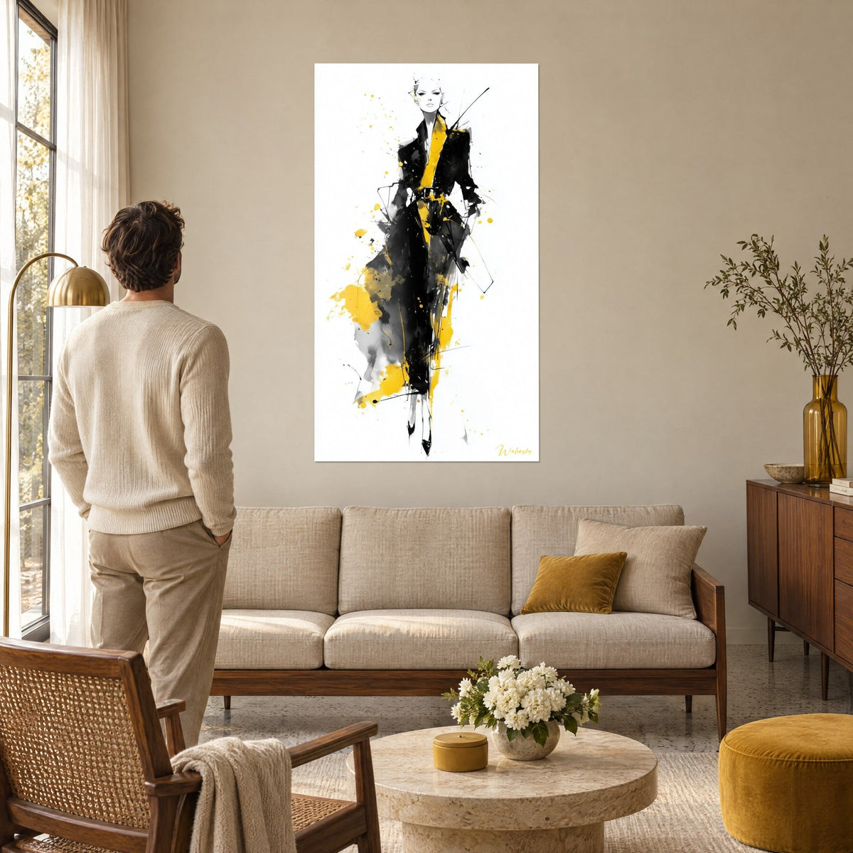 Wall art slender long-legged model in a black coat with mustard-yellow splashes, man seen from behind, above a sofa in a bright living room