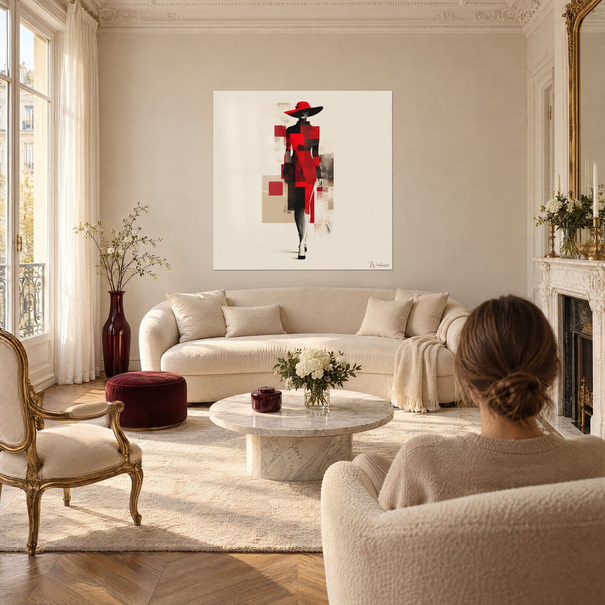 Wall art female silhouette under a wide red hat, dress in plum and black flat blocks on a beige background, above a sofa in a bright living room