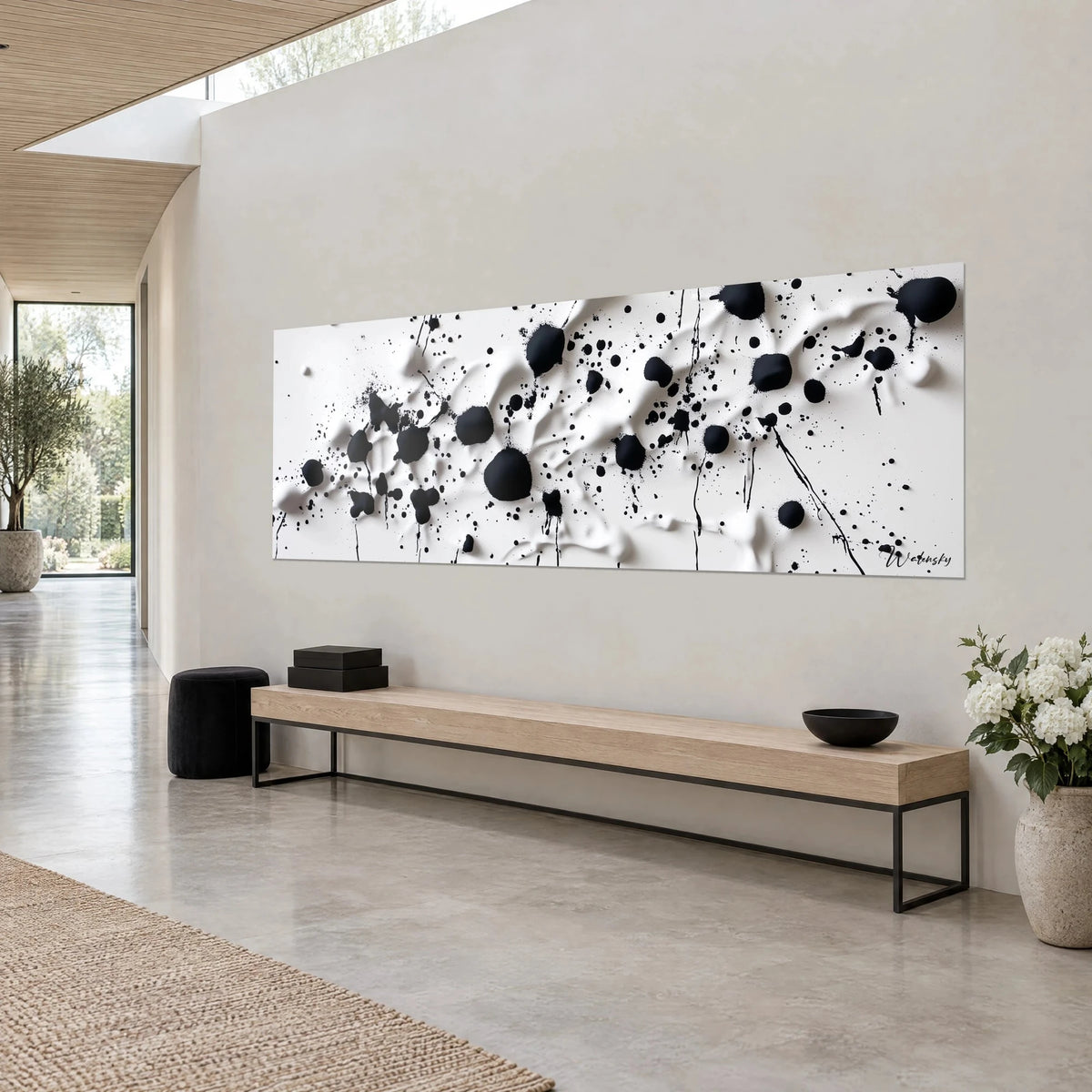 Wall art with matte black drops and fine drips on wavy ivory background, angled view, on a grey wall of an architect-designed house