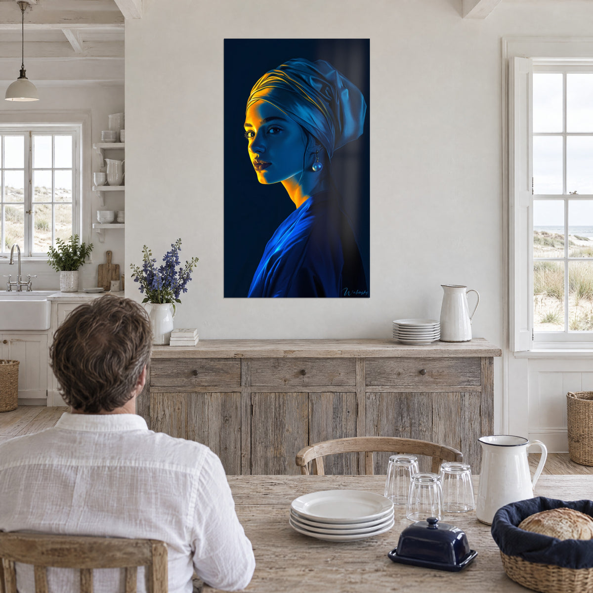Quadro giovane donna con turbante, guancia dorata e cappotto blu reale, appeso in una sala da pranzo luminosa dove un uomo lo guarda di spalle