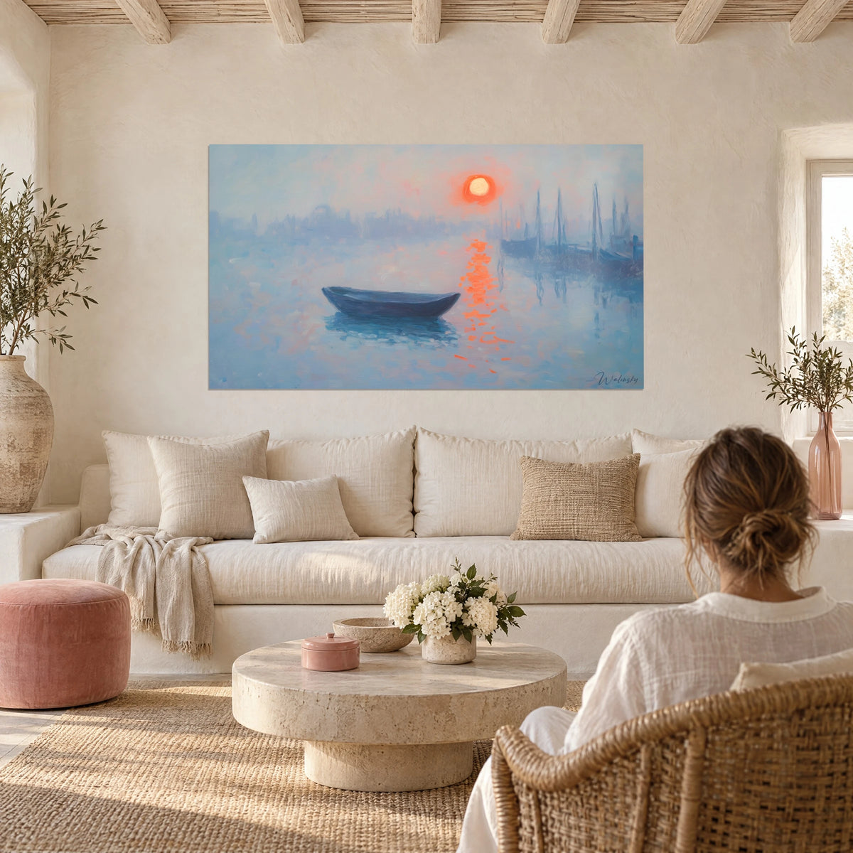 Wall art rising orange sun over a bluish mist, dark boat and blazing reflections, above a sofa in a bright living room